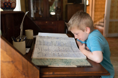 Child reading historic book