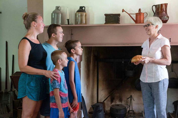 Teacher teaching a family about history at the mansion