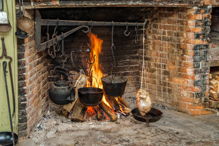 Open hearth cooking - fireplace with open fire and cooking containers