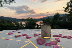 Candle on table at sunset