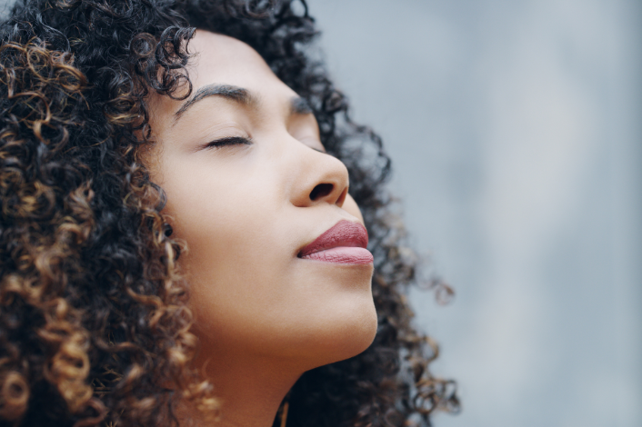 Women with her eyes closed meditating