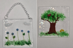 clear glass suncatchers with flowers, trees, grass and other nature elements