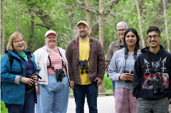 Group of people all with binoculars