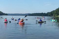 Group of people paddling down the Susquehanna river in kayaks