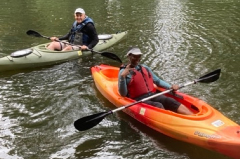 Two people in kayaks paddling