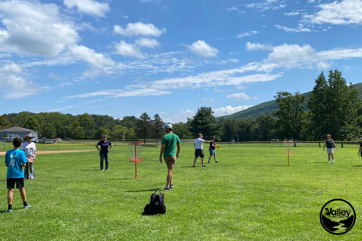 People playing disc golf