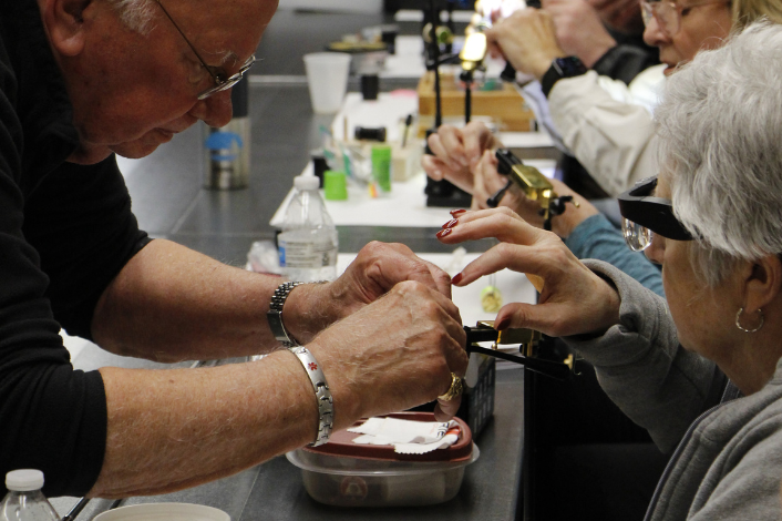 Instructor helping a participant with tying a fly