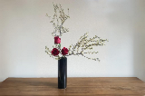 Black Vase with Red Roses and greens