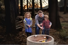 Family roasting marshmallows around a fire