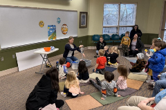 Educator reading to a group of children