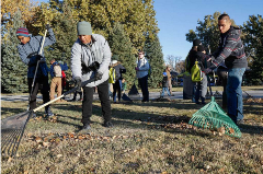 community members raking up leaves at the park